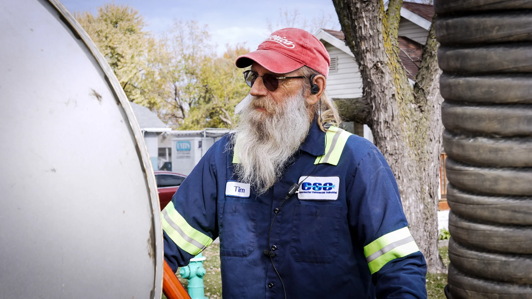 Workman accessing road hatches for vacuum truck service