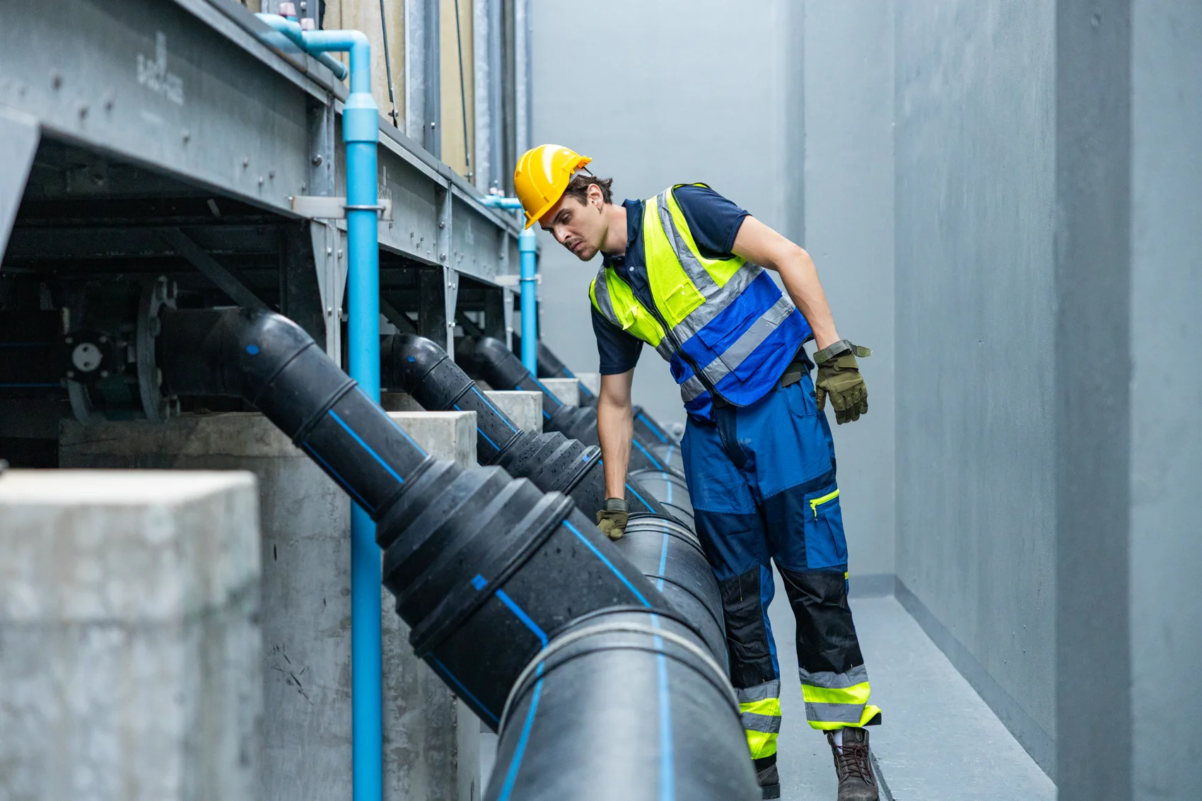 Engineer inspecting an industrial pipeline for grease buildup