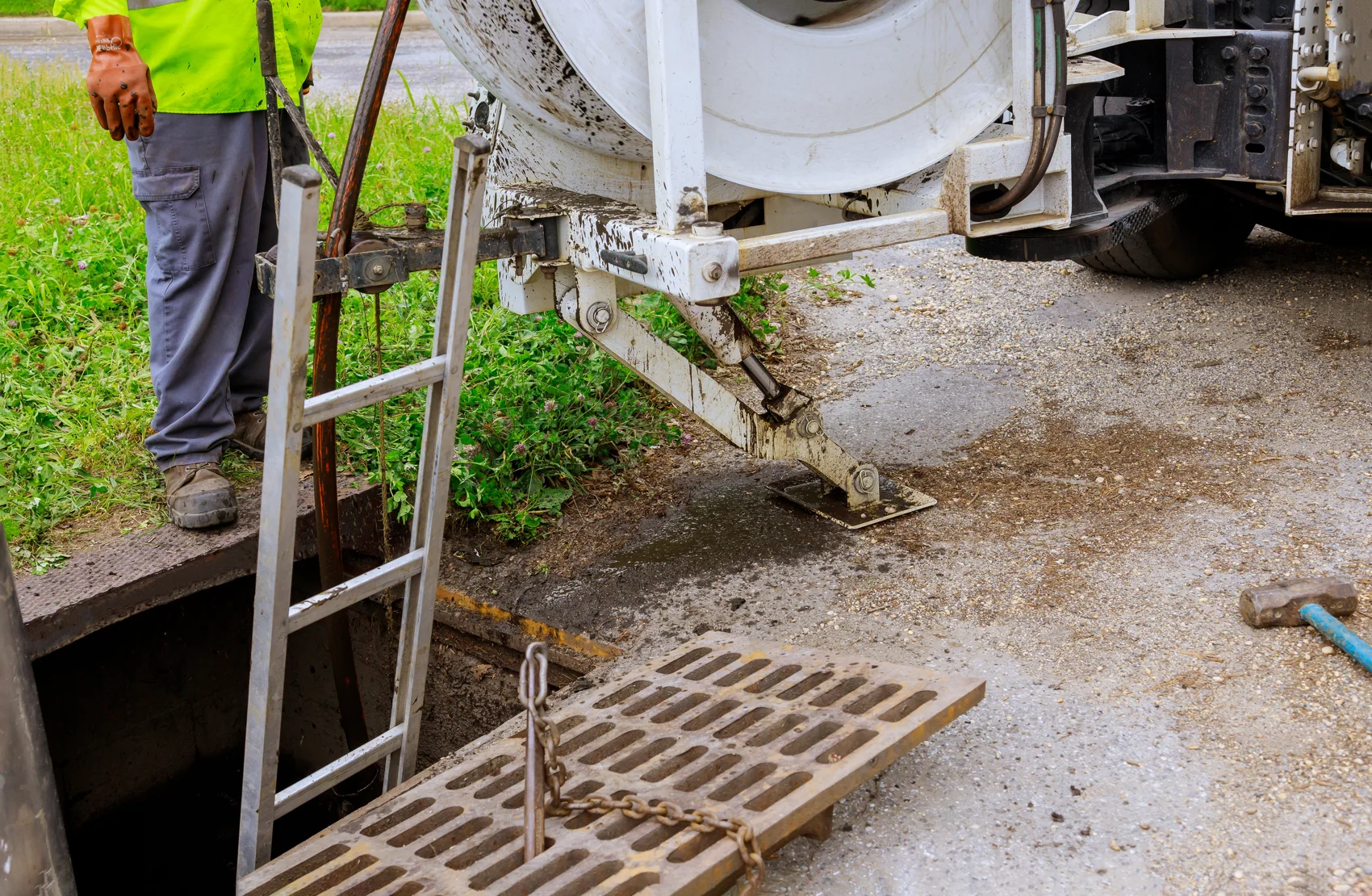 Sewer cleaning crew with equipment servicing a commercial grease system