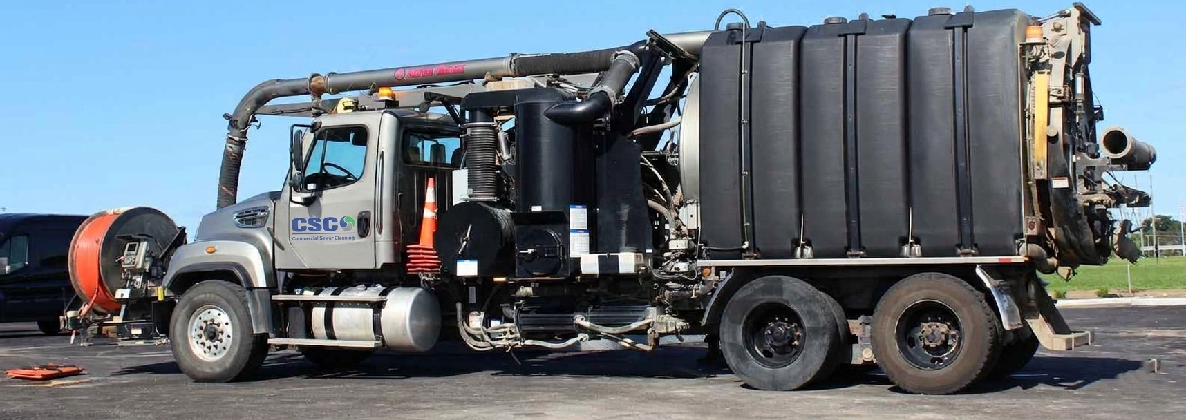 Workman accessing road hatches for vacuum truck service
