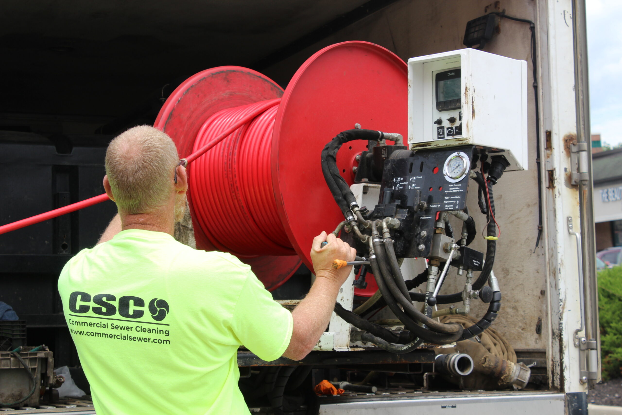Crew performing scheduled sewer maintenance on a commercial system