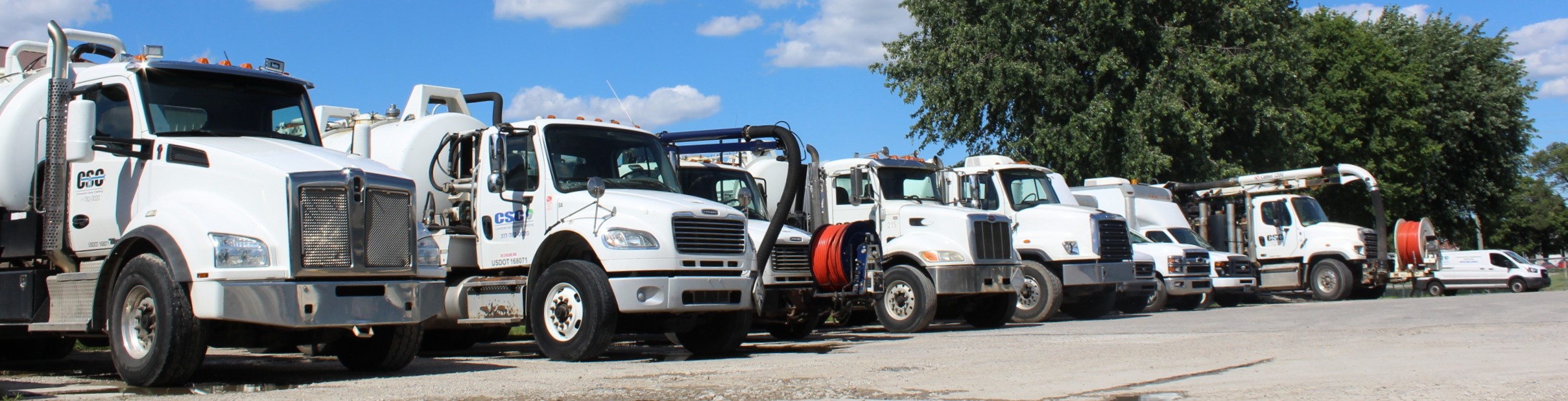 Technician connecting a large suction hose to a vacuum truck